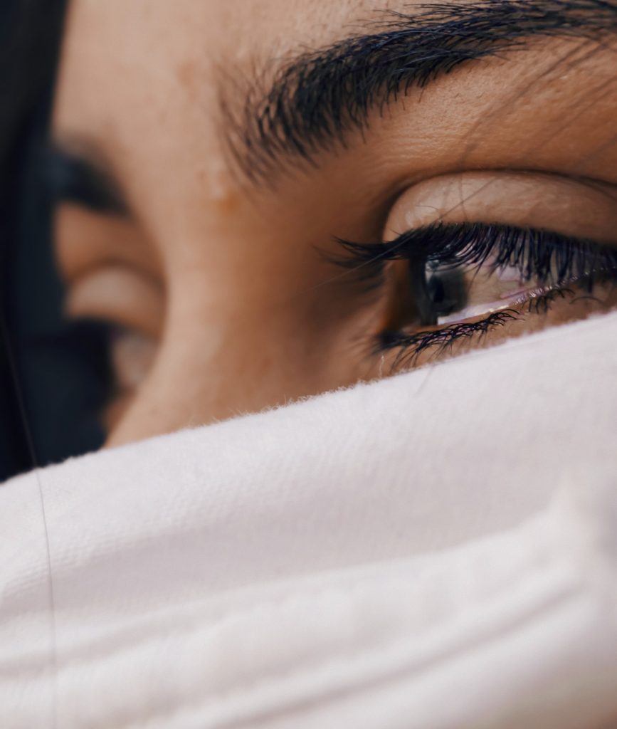 A close up of a person with watery eyes, representing the pain postpartum depression therapy in Atlanta, GA can address. Learn more about online postpartum therapy in Atlanta, GA by contacting a postpartum depression therapist in Atlanta, GA today.