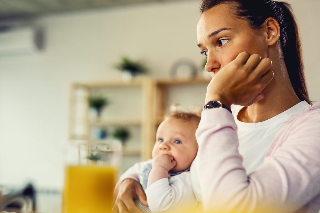 A mother and baby each sit with a hand resting against their cheeks. A postpartum depression therapist in Atlanta, GA can help you address postpartum symptoms with online postpartum therapy in Atlanta, GA. Learn more about postpartum anxiety therapy and other services.