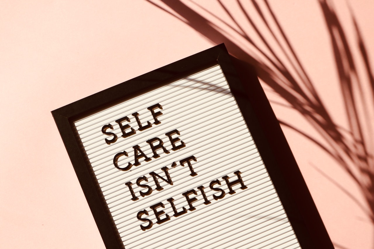 A sign that reads self care isn't selfish. Learn how treatment for depression in atlanta, ga can offer support in cultivating self care. Contact an online depression therapist in Atlanta, GA for support